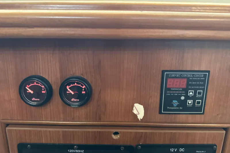 Slide: The Image of Electrical control panel on a 2014 Gemini Legacy 35 boat, featuring AC and DC switches. - 31
