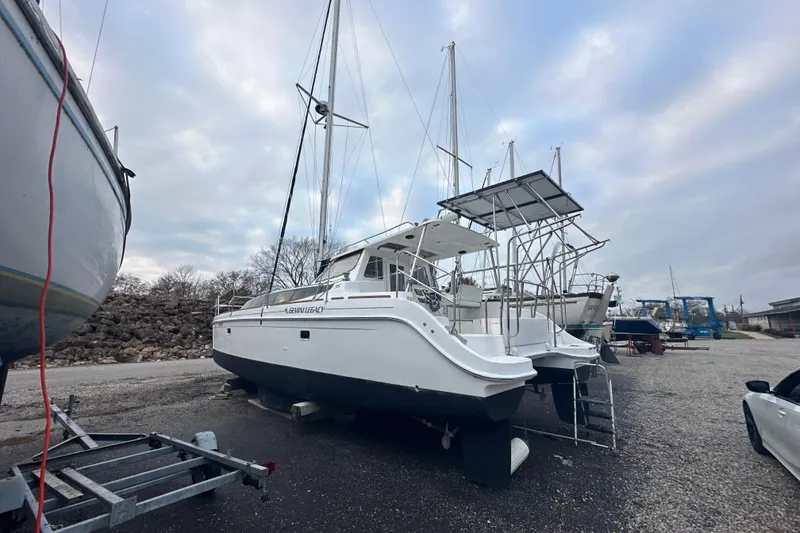 Slide: The Image of 2014 Gemini Legacy 35 catamaran on dry dock under cloudy sky. - 56