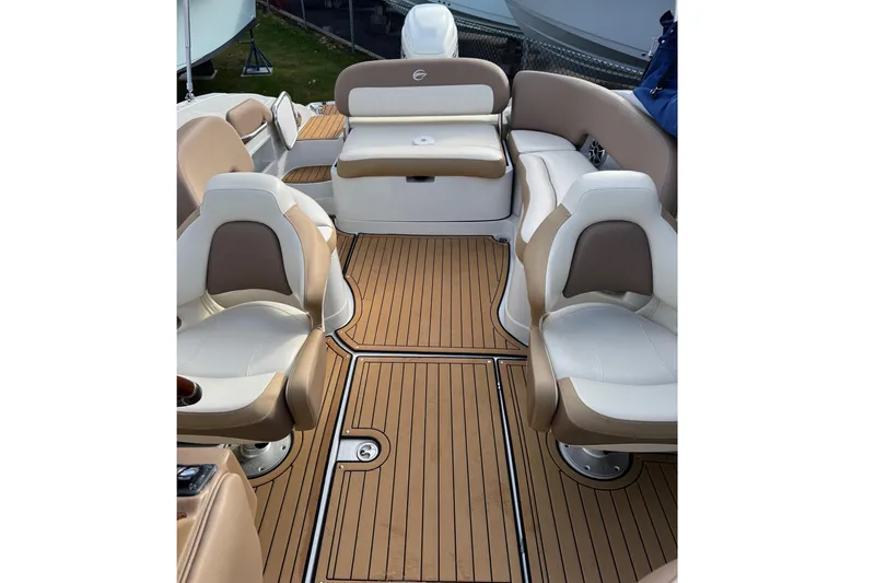 Slide: The Image of 2021 Crownline Eclipse E255 XS boat interior with tan and white seating. - 3