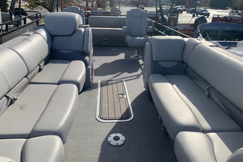 Slide: The Image of 2024 Regency 250 DL3 pontoon boat interior with plush gray seating and spacious layout. - 4