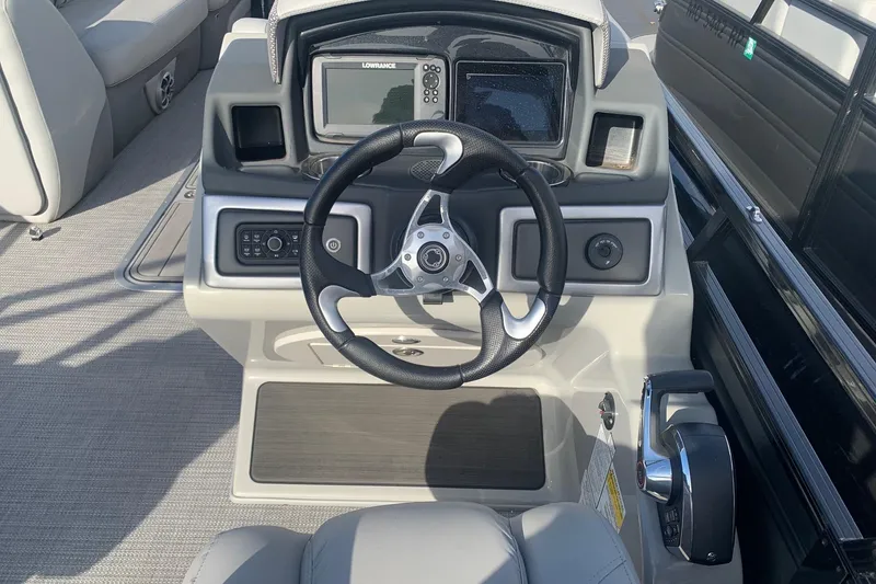 Slide: The Image of 2024 Regency 250 DL3 boat dashboard with steering wheel and navigation system. - 5