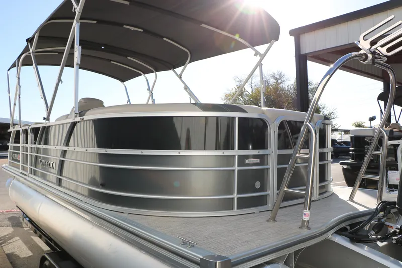 Slide: The Image of 2023 Sylvan Mirage X X3 Party Fish pontoon boat with canopy, docked outdoors. - 12