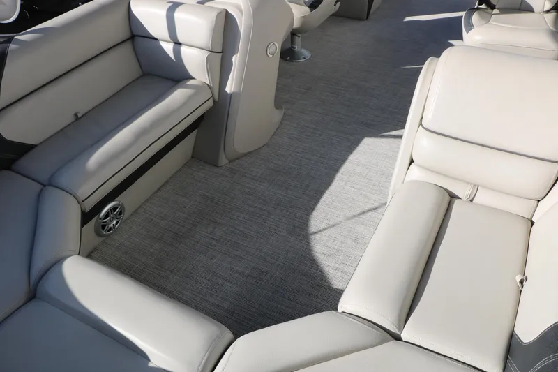 Slide: The Image of 2023 Sylvan Mirage X X3 Party Fish boat interior with beige seating and carpeted floor. - 14