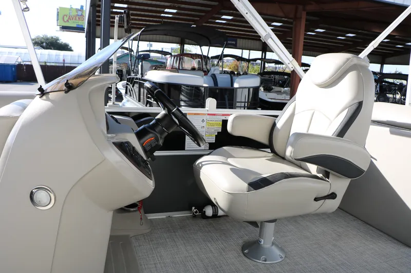 Slide: The Image of 2023 Sylvan Mirage X X3 Party Fish boat interior with captain's chair and steering console. - 23