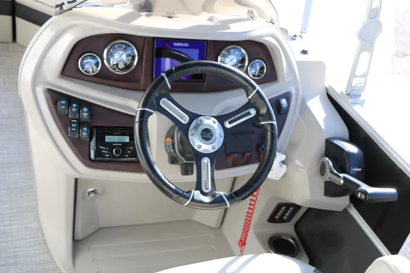 Slide: The Image of 2023 Sylvan Mirage X X3 Party Fish boat dashboard with steering wheel and controls. - 25