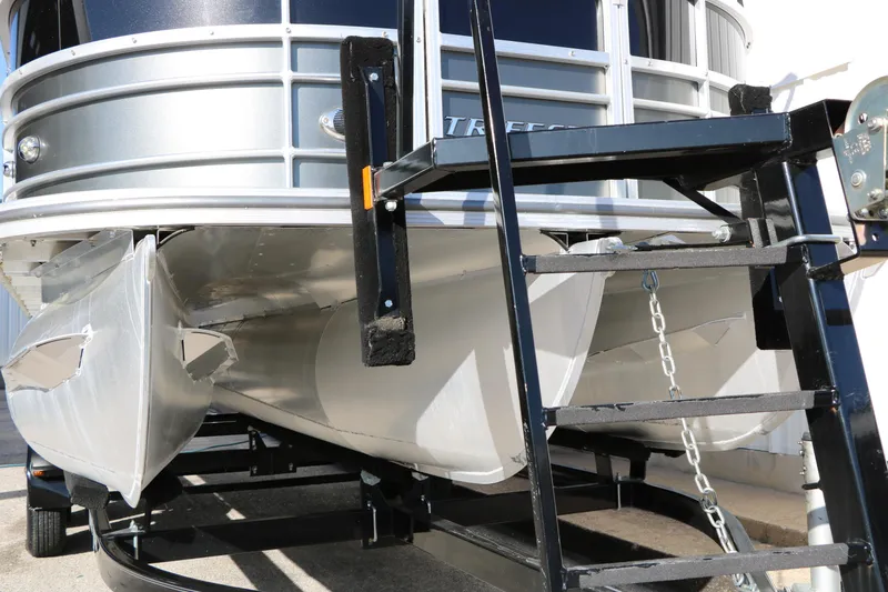 Slide: The Image of 2023 Sylvan Mirage X X3 Party Fish pontoon boat on trailer, close-up view. - 6