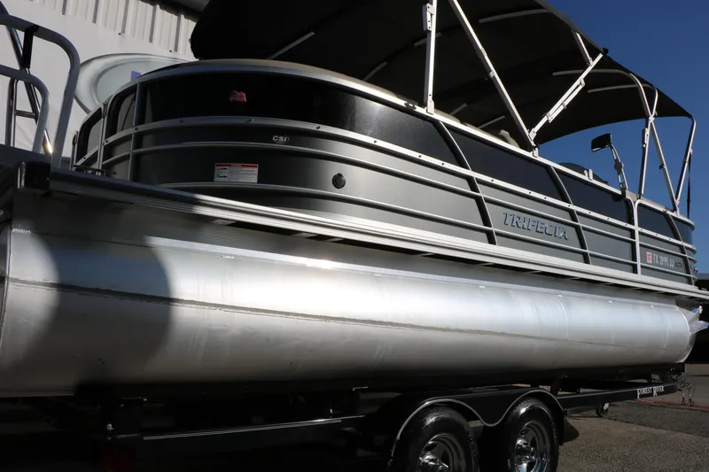Slide: The Image of 2023 Sylvan Mirage X X3 Party Fish pontoon boat on trailer, side view. - 7