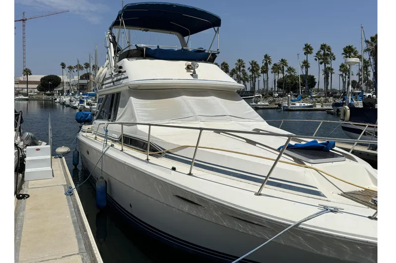 The Image of 1985 Sea Ray 340 Sedan Bridge docked in marina. - 1