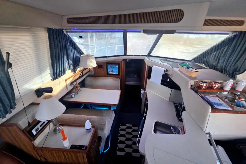 Slide: The Image of Interior of a 1985 Sea Ray 340 Sedan Bridge yacht with cozy seating and nautical decor. - 10