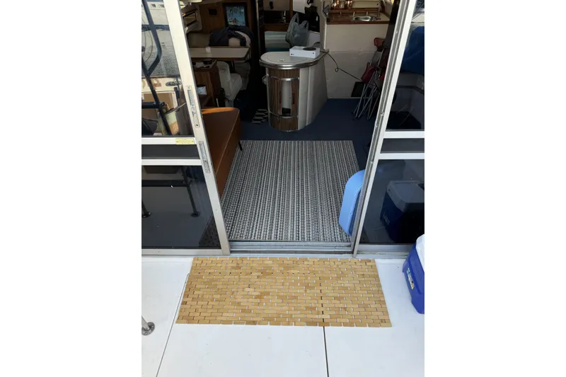 Slide: The Image of Interior view of 1985 Sea Ray 340 Sedan Bridge boat with open sliding door. - 4