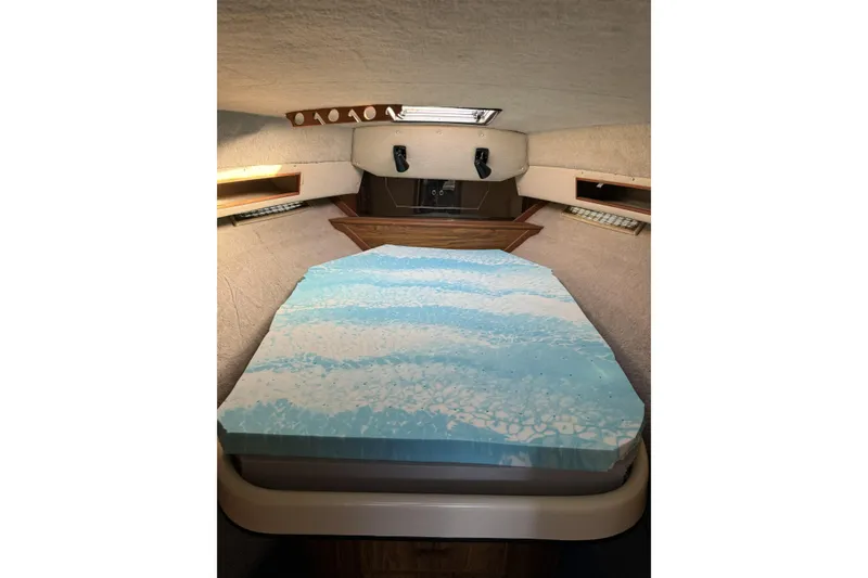 Slide: The Image of Interior cabin of 1985 Sea Ray 340 Sedan Bridge with a patterned mattress. - 5