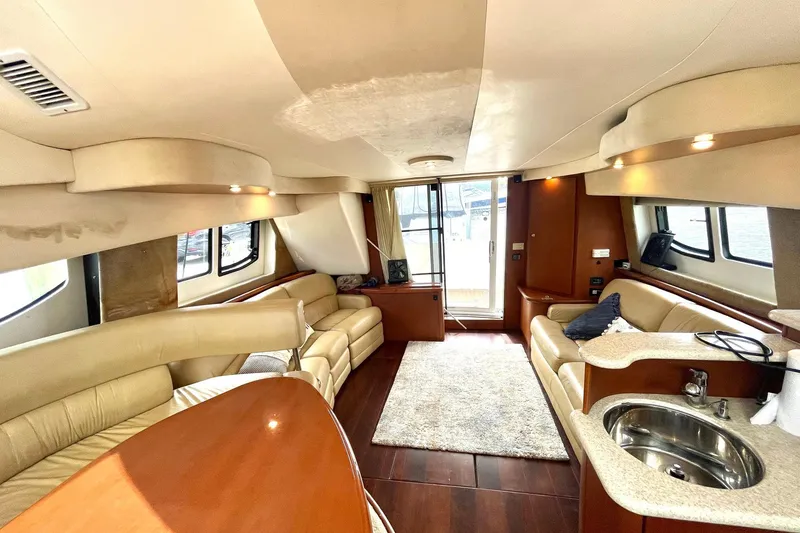 Slide: The Image of Luxurious interior of a 2005 Silverton 43 Sport Bridge yacht with plush seating and modern amenities. - 13
