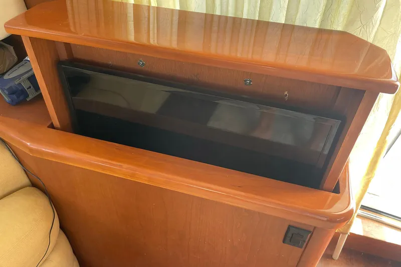Slide: The Image of 2005 Silverton 43 Sport Bridge interior with retractable TV cabinet. - 16