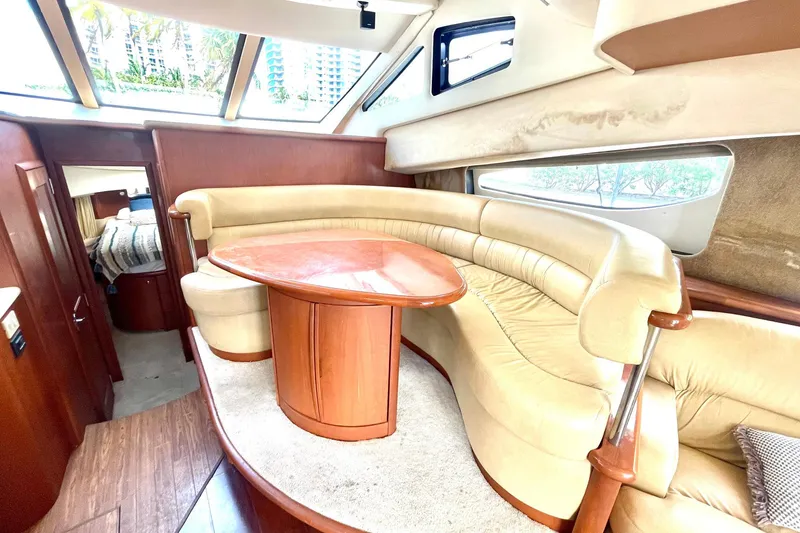 Slide: The Image of Luxurious interior of 2005 Silverton 43 Sport Bridge yacht with plush seating and wooden table. - 17