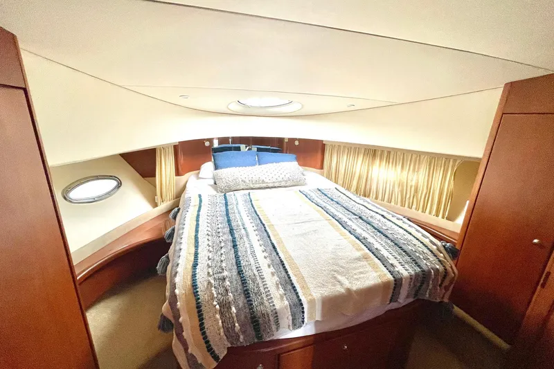 Slide: The Image of Luxurious cabin interior of 2005 Silverton 43 Sport Bridge yacht with cozy bed and porthole. - 21