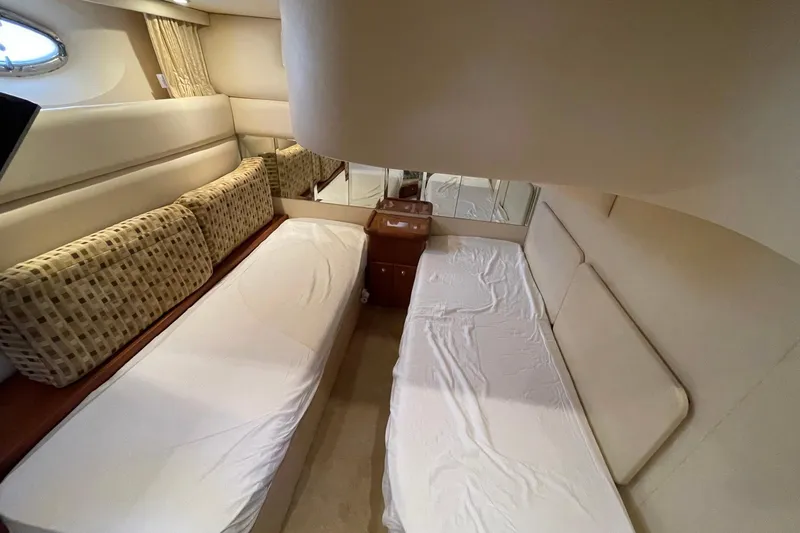 Slide: The Image of 2005 Silverton 43 Sport Bridge cabin with twin beds and elegant interior design. - 22
