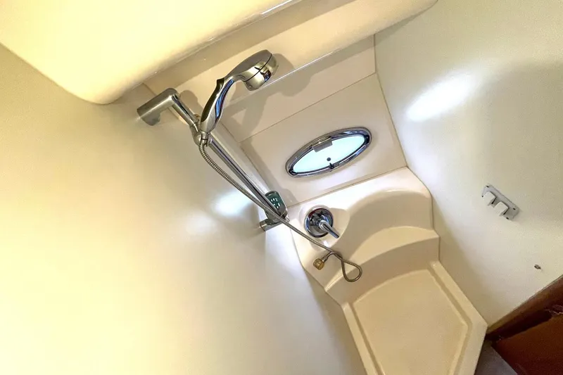 Slide: The Image of Shower area in 2005 Silverton 43 Sport Bridge yacht with porthole and chrome fixtures. - 24