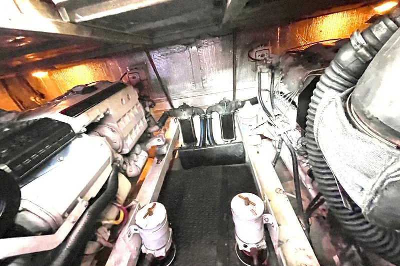 Slide: The Image of Engine room of a 2005 Silverton 43 Sport Bridge yacht, showcasing mechanical components. - 25
