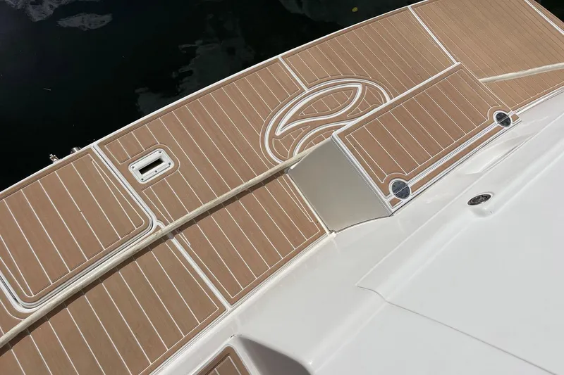 Slide: The Image of 2005 Silverton 43 Sport Bridge boat deck with teak-style flooring. - 28