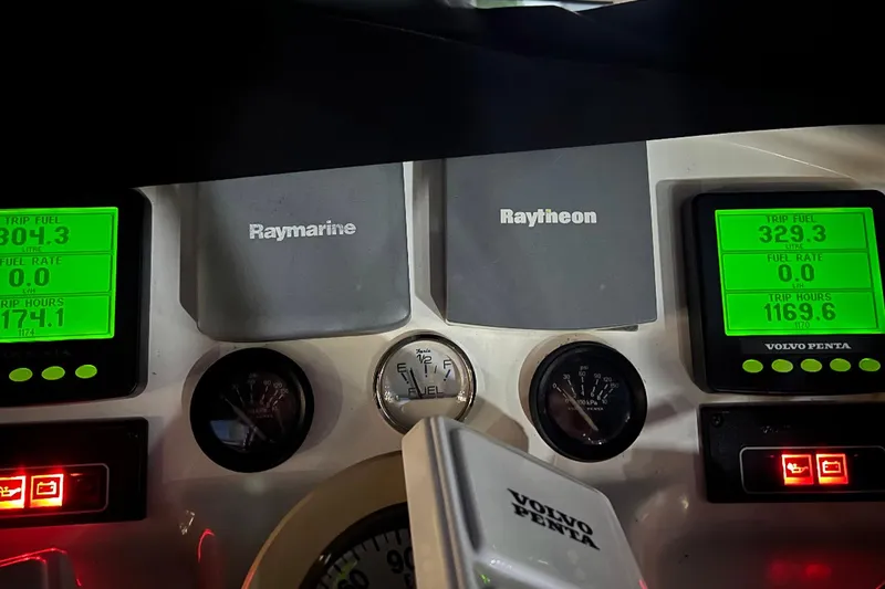 Slide: The Image of Dashboard of a 2005 Silverton 43 Sport Bridge with Raymarine and Raytheon displays. - 7