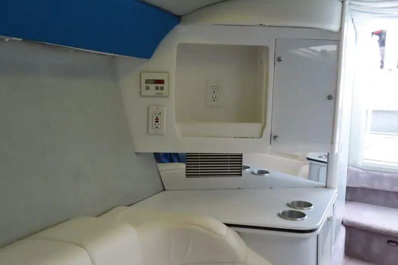 Slide: The Image of Interior of 1999 Formula 382 FASTech boat with white seating and storage compartments. - 17