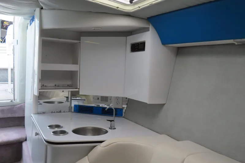 Slide: The Image of 1999 Formula 382 FASTech boat interior with kitchenette and seating area. - 18