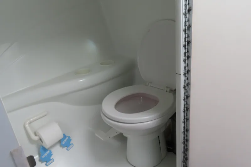 Slide: The Image of 1999 Formula 382 FASTech boat bathroom with toilet and toilet paper holder. - 21
