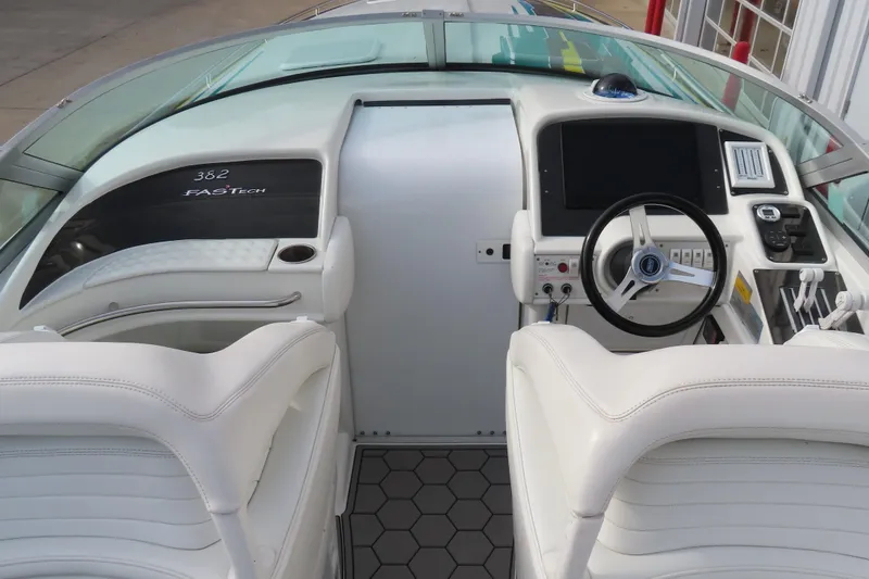 Slide: The Image of 1999 Formula 382 FASTech boat cockpit with white leather seats and modern controls. - 8