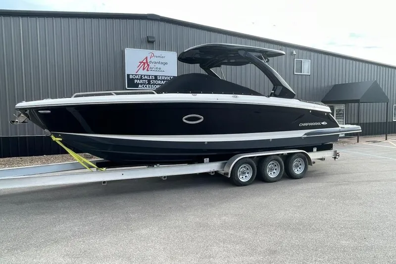 The Image of 2024 Chaparral 307 SSX boat on a trailer outside a marine sales building. - 0