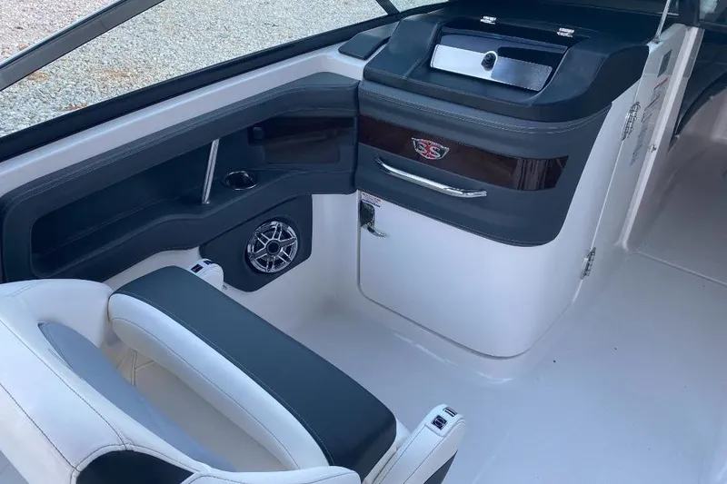 Slide: The Image of 2024 Chaparral 307 SSX boat interior with sleek seating and modern dashboard design. - 11