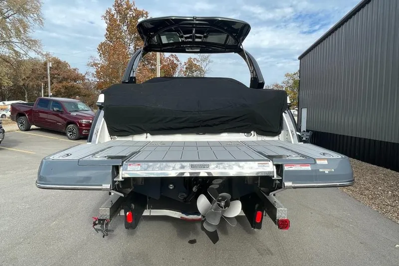 Slide: The Image of 2024 Chaparral 307 SSX boat rear view with propeller and swim platform. - 2