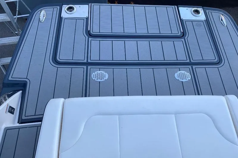 Slide: The Image of 2024 Chaparral 307 SSX boat deck with sleek gray and white design. - 7
