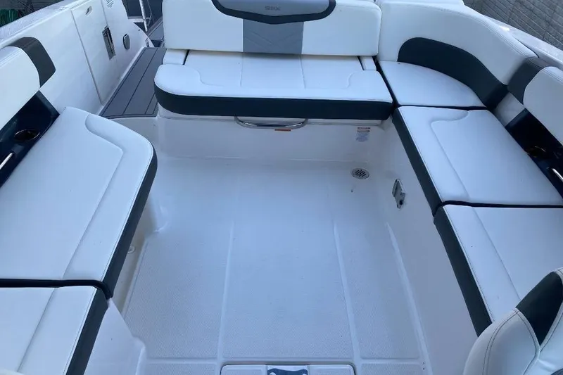 Slide: The Image of 2024 Chaparral 307 SSX boat interior with white and gray seating arrangement. - 8