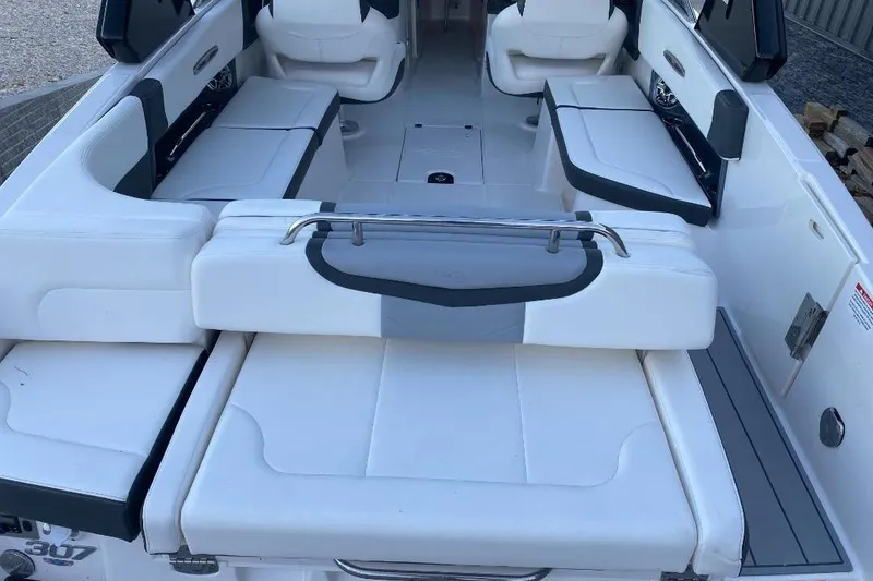 Slide: The Image of 2024 Chaparral 307 SSX boat interior with white seating and modern design. - 9