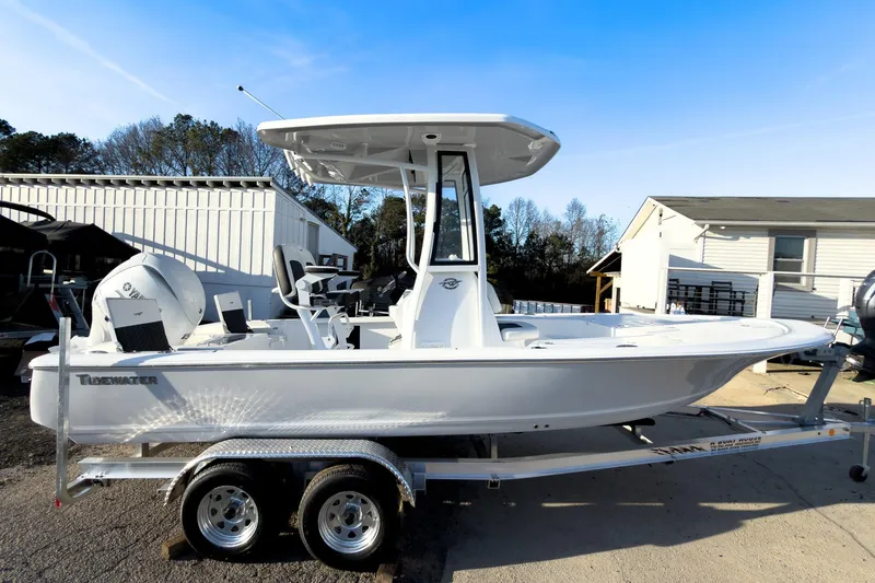 The Image of 2026 Tidewater 2110 Bay Max boat on trailer, parked outdoors under clear blue sky. - 0