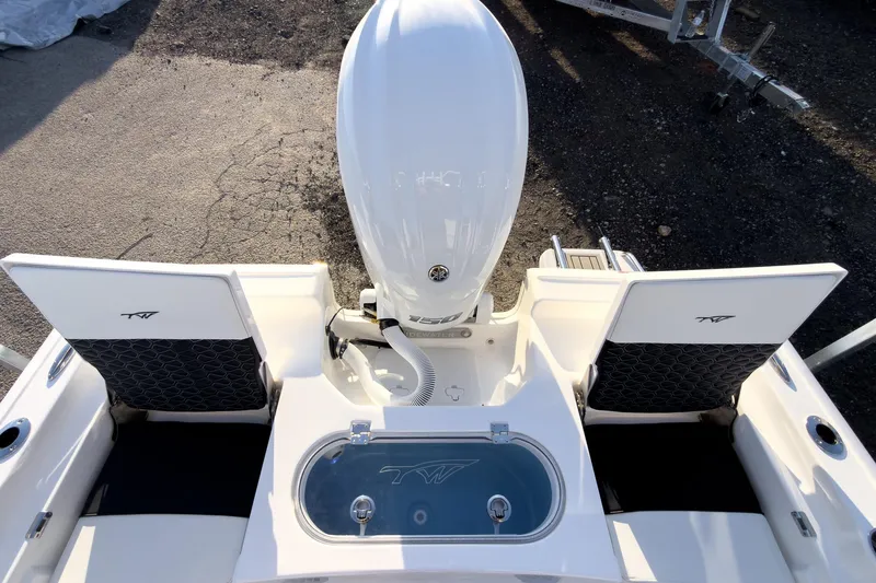 Slide: The Image of 2026 Tidewater 2110 Bay Max boat, rear view with engine and seating. - 11