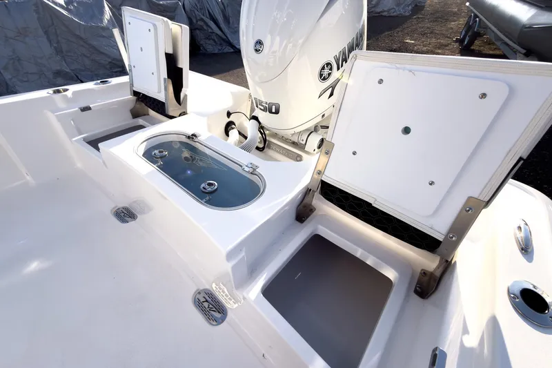 Slide: The Image of 2026 Tidewater 2110 Bay Max boat interior with Yamaha engine and storage compartments. - 13