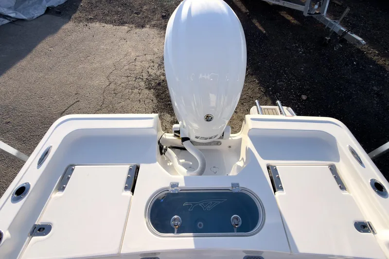 Slide: The Image of 2026 Tidewater 2110 Bay Max boat stern with outboard motor and storage compartments. - 14