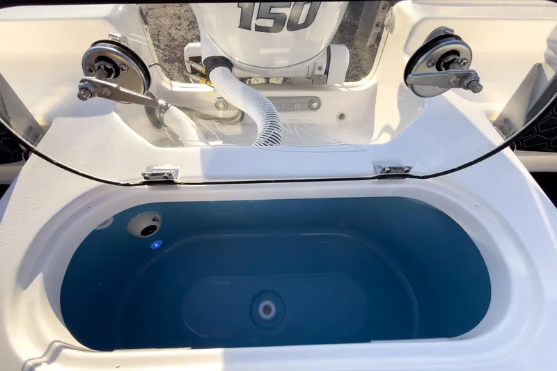 Slide: The Image of 2026 Tidewater 2110 Bay Max livewell with open lid and blue interior. - 15
