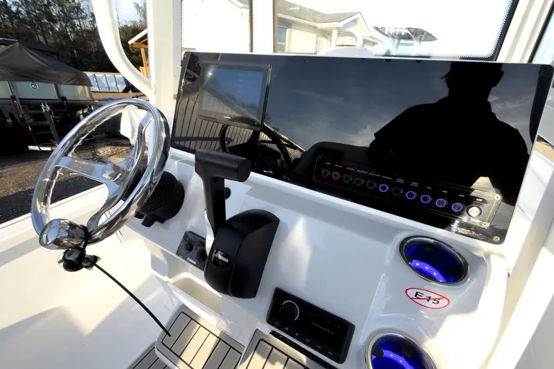 Slide: The Image of 2026 Tidewater 2110 Bay Max boat dashboard with steering wheel and control panel. - 21