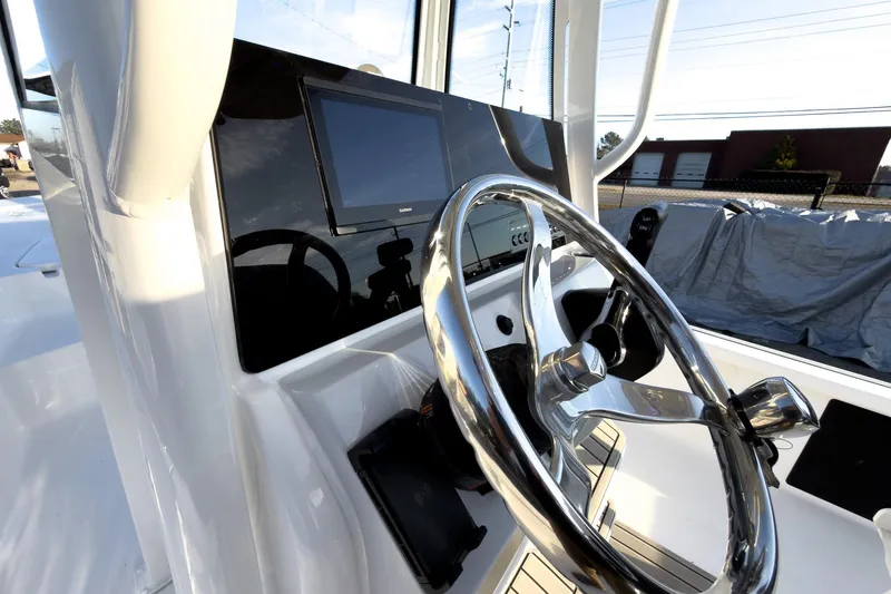 Slide: The Image of Steering console of 2026 Tidewater 2110 Bay Max boat with modern controls. - 23