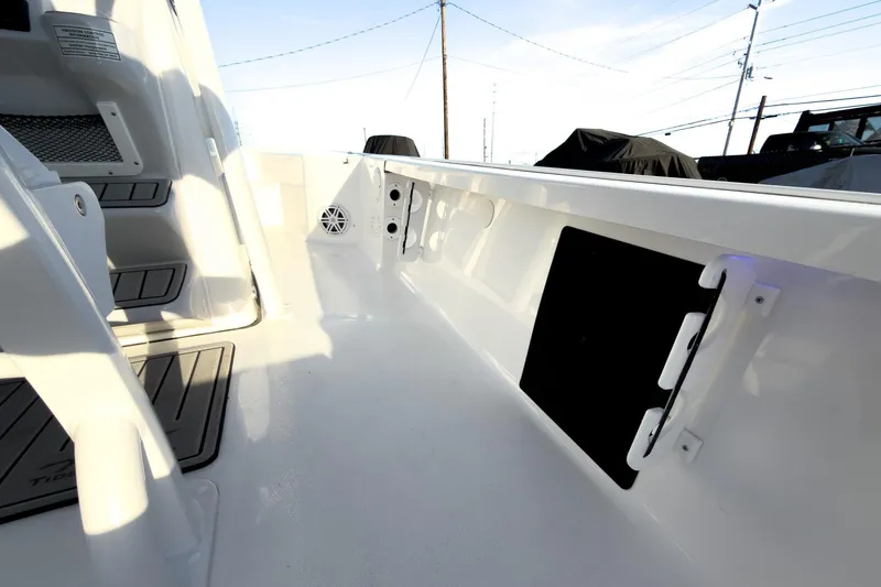 Slide: The Image of 2026 Tidewater 2110 Bay Max boat interior with sleek white design and storage compartments. - 29
