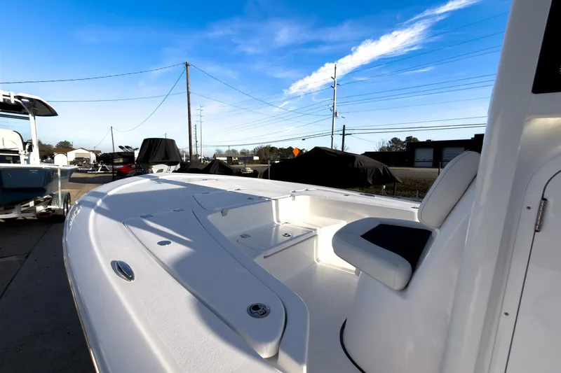 Slide: The Image of 2026 Tidewater 2110 Bay Max boat with sleek white deck and seating, under clear blue sky. - 31