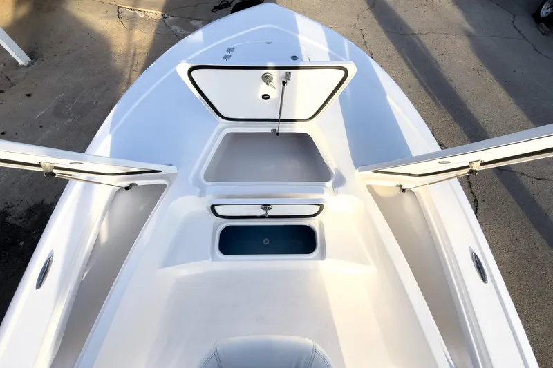Slide: The Image of 2026 Tidewater 2110 Bay Max boat interior with open storage compartments. - 34