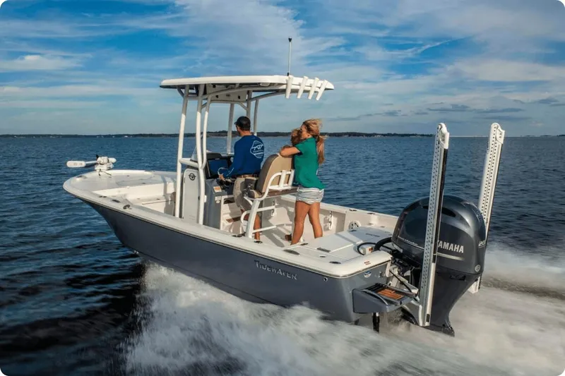 Slide: The Image of 2026 Tidewater 2110 Bay Max boat with modern seating and console, docked outdoors. - 5