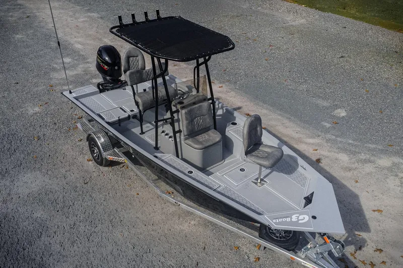 The Image of 2026 G3 Bay 19 GX boat on trailer, featuring sleek design and modern seating. - 1