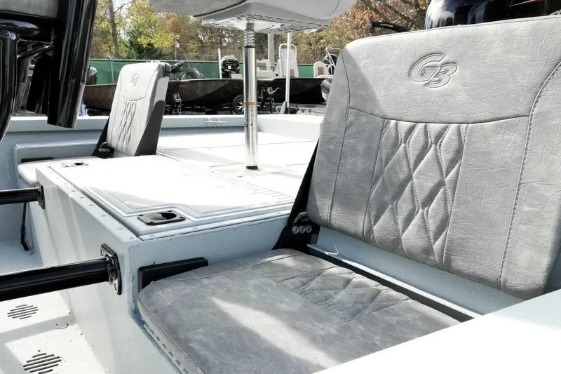 Slide: The Image of 2026 G3 Bay 19 GX boat interior with gray cushioned seats and sleek design. - 13