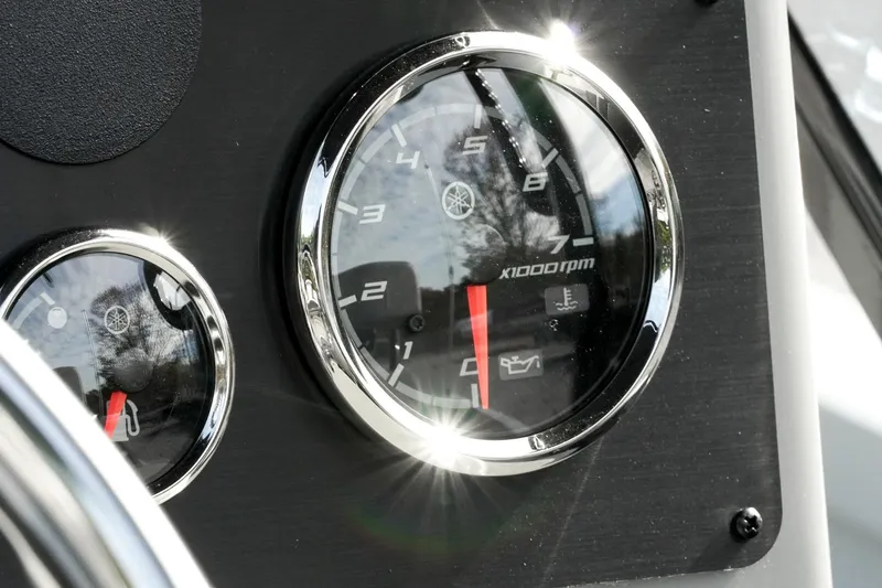 Slide: The Image of Close-up of 2026 G3 Bay 19 GX boat dashboard gauges, showing RPM and temperature indicators. - 17