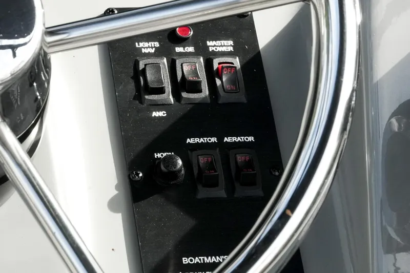 Slide: The Image of Control panel of 2026 G3 Bay 19 GX boat with switches and steering wheel. - 18