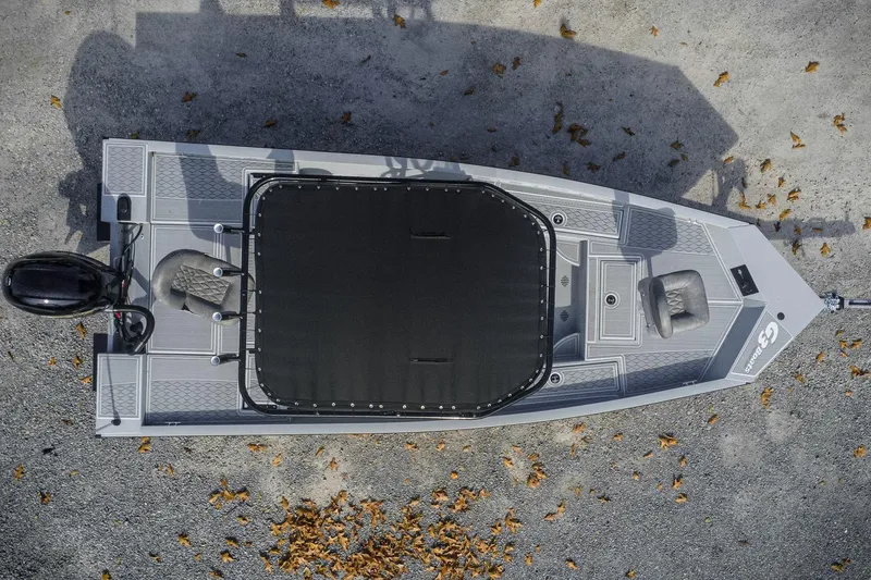 Slide: The Image of Top view of 2026 G3 Bay 19 GX boat on gravel with scattered leaves. - 2
